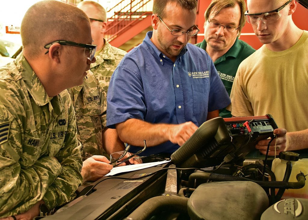 RI Air Guard personnel learning to use a scan tool to identify vehicle engine and electrical problems 