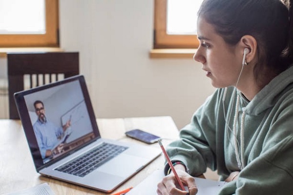 Young women at home during pandemic isolation learning.