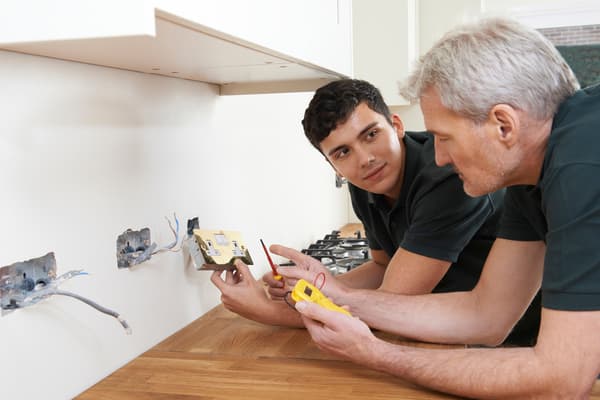 An electrical apprentice undergoing training