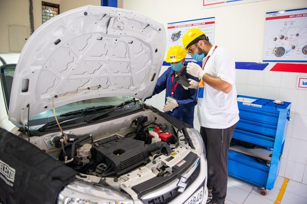 Auto mechanic professionals working on a car