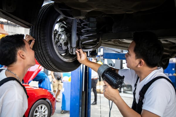 Auto mechanics repairing the wheel