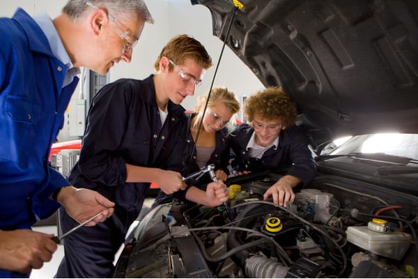 Car technicians working in lab