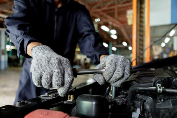 Mechanic apprentice training on automobile