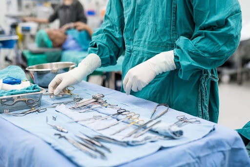 Scrub nurse preparing medical instruments for operation